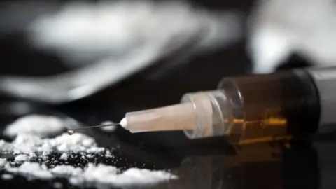 Getty Images Needle beside powder