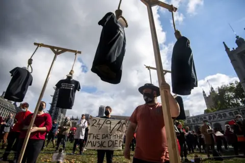 Victoria Jones / PA Media Workers from the live entertainment sector join a silent protest in Parliament Square, London