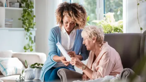 Getty Images A carer with a patient