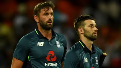 England players Liam Plunkett (left) and Mark Wood (right) walk off after defeat by West Indies in the second ODI in Barbados
