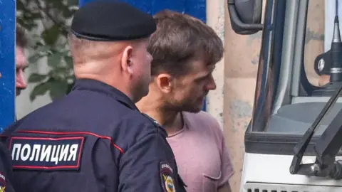 Getty Images The Pussy Riot punk group member Pyotr Verzilov (R) leaves a detention centre in Moscow on July 30, 2018