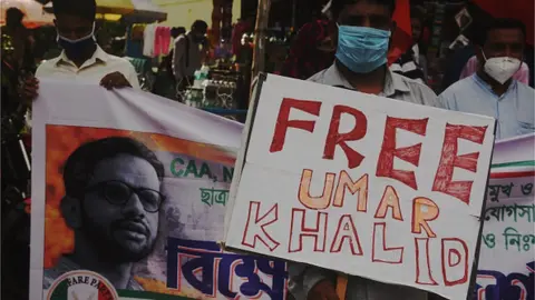 Getty Images Members of the Welfare Party of India hold banners during a protest against the arrest of Umar Khalid under the UAPA charges in Delhi riots case, at Esplanade, on September 18, 2020 in Kolkata, India.