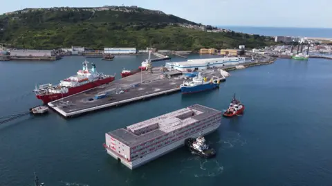 Bibby Stockholm arrives at Portland Port