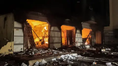 AFP This picture taken early on July 2, 2022 shows a fire inside the building used by Libya's Tobruk-based parliament building in the country's east, lit up by protesters who broke inside while demonstrating against deteriorating living conditions and political deadlock.