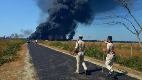 Getty Images Smoke billowing from a blaze in a gas well in India's Assam