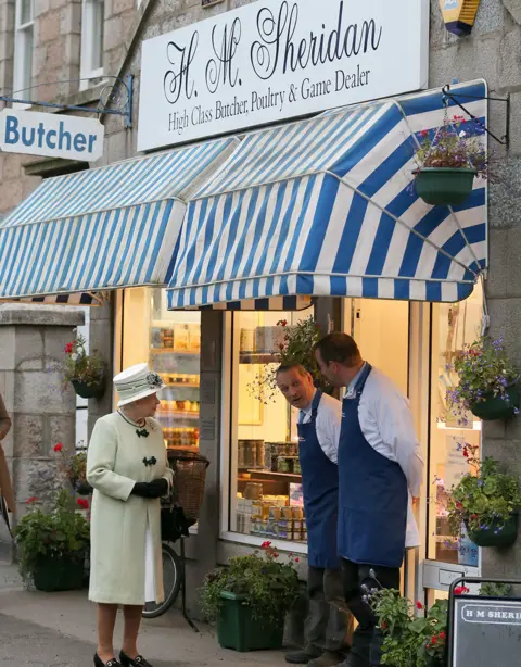 PA Media File photo dated 27/9/2012 of Queen Elizabeth II talks to the local butchers, in Ballater, Aberdeenshire, prior to unveiling a plaque marking a special Diamond Jubilee cairn close to her Balmoral Estate. Scotland was a special place for the Queen over the decades, both for holidays and royal duties. She spent part of her honeymoon at Birkhall on the rural Balmoral estate in Aberdeenshire and the estate was her favoured residence in Scotland. Issue date: Thursday September 8, 2022.