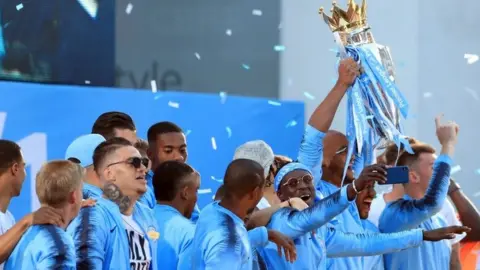 PA Manchester City players celebrate with the Premier League trophy