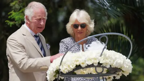 PA Media The Prince of Wales and the Duchess of Cornwall laid a wreath at the Kigali Genocide Memorial, as part of their visit to Rwanda