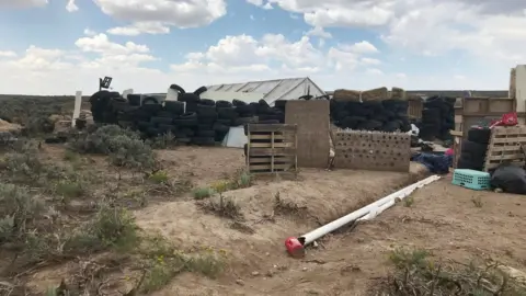 Reuters A view of the compound in rural New Mexico where 11 children were taken in protective custody after a raid by authorities near Amalia, New Mexico, on 10 August 2018.