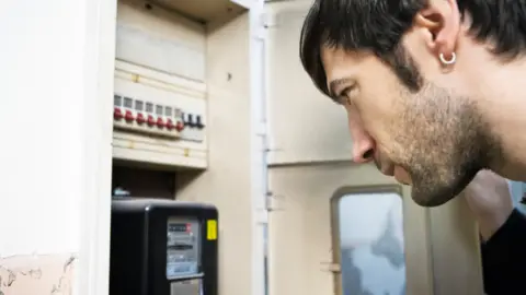 Getty Images Man checks meter