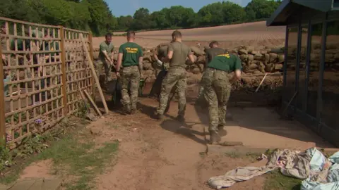 Royal Marines building sand bag wall