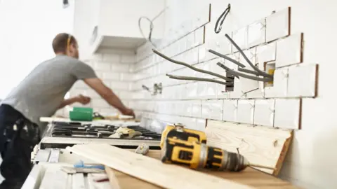 Getty Images A man carries out household DIY