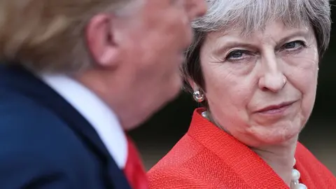 Getty Images Britain"s Prime Minister Theresa May (R) listens as US President Donald Trump (L) speaks during a joint press conference following their meeting at Chequers, the prime minister"s country residence, near Ellesborough, northwest of London on July 13, 2018