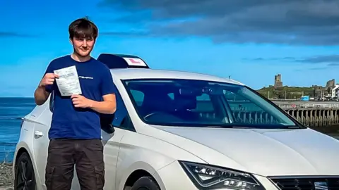 Connor Davies Connor Davies holding his driver's certificate.