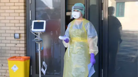 PA Media An A&E nurse during a demonstration of the coronavirus pod and Covid-19 virus testing procedures set-up at Antrim Area Hospital in Northern Ireland