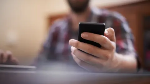 Getty Images Man texting