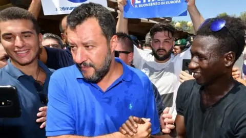 AFP Matteo Salvini shakes hands with a supporter during his electoral tour "Italian Summer Tour" in Policoro on August 10