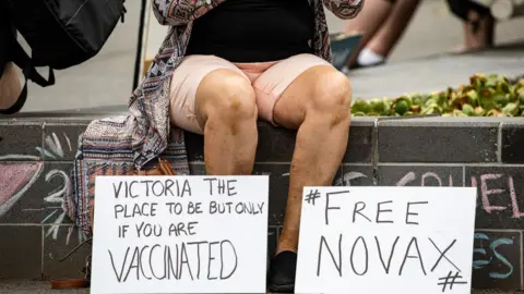 Getty Images signs saying "Free Novax" - a play on the tennis star's name