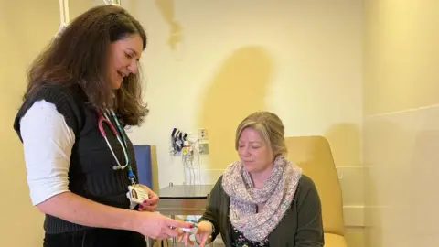 NHS Cornwall A GP treating a patient