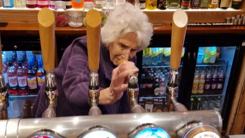 Tanglewood Care Services Ltd Liliana Scott pouring a pint