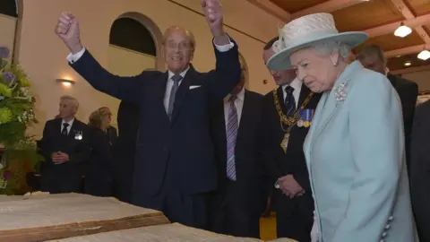 Pacemaker The Queen and Prince Philip look at old newspapers from World War One at Coleraine Town Hall during a visit to Northern Ireland in 2014