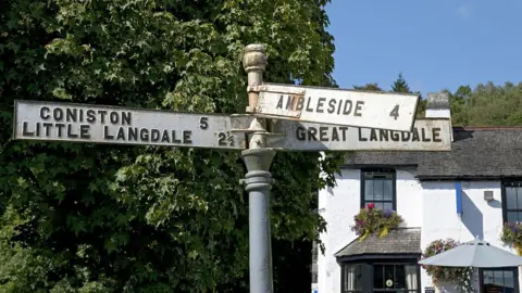 Getty Images Road signs for several Lake District villages