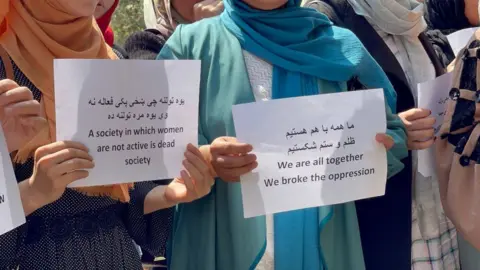 Haroon Sabawoon/Anadolu/Getty Images Women protesting in front of Vice and Virtue Ministry, Sept 2021