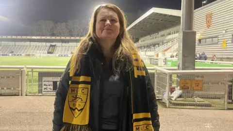 BBC/Daniel Sexton Lorraine Humm standing at the Gallagher Stadium