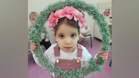 Yoni Asher Aviv pictured holding tinsel