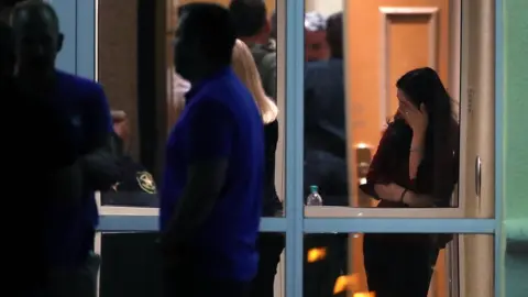 Getty Images People gathered outside a hotel