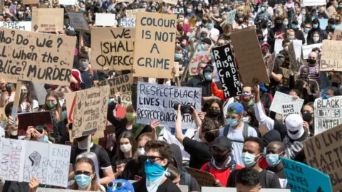 EPA Protesters held placards during a demonstration at Glasgow Green in Glasgow on Sunday