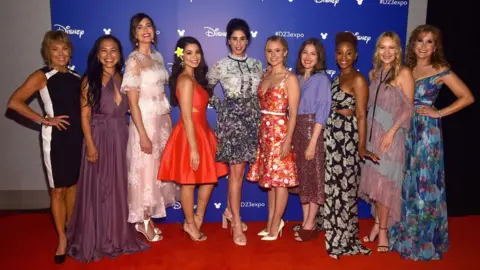 Getty Images Paige O'Hara (Beauty and the Beast), Irene Bedard (Pocahontas), Mandy Moore (Rapunzel), Auli'i Cravalho (Moana), Sarah Silverman (Wreck It Ralph), Kristen Bell (Frozen), Kelly Macdonald (Brave), Anika Noni Rose (The Princess And The Frod), Linda Larkin (Aladdin), and Jodi Benson (The Little Mermaid)