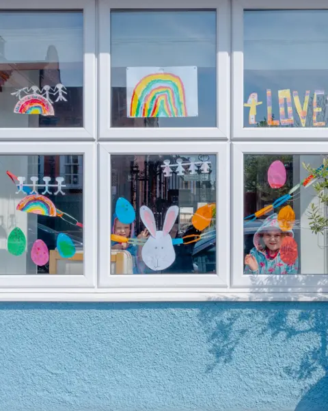 Tom Skipp Isla and Evan at the window