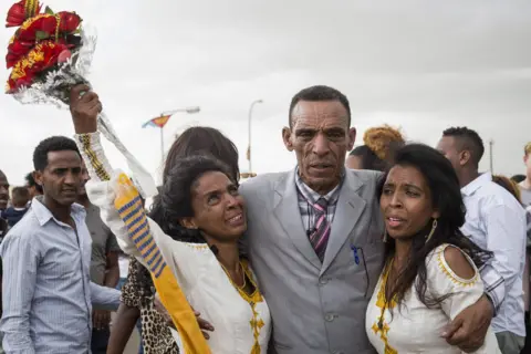 AFP Azmera Addisalem and Danait Addisalem get emotional as they see again their father (who is an Ethiopian journalist) for the first time in 20 years, upon his arrival at the Asmara International airport, on July 18, 2018.