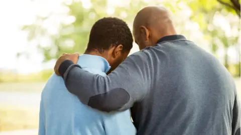 Getty Images Father hugging his son