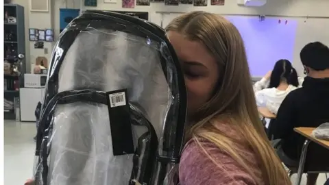 Reuters Student returning to Marjory Stoneman Douglas High in the US with a clear backpack - part of a new policy to combat school shootings, 2 April 2018