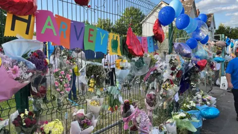 Tributes were attached to a fence in their memory