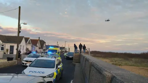 Ed Schooling Police cars at the Jaywick Sands seafront