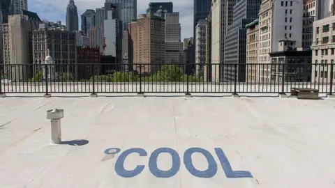 Getty Images Cool, white roofing materials to cool the roof of a federal building on Broadway in New York City. The word Cool has been spelled out on the rooftop of this building.