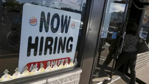 Reuters Sign saying "now hiring"