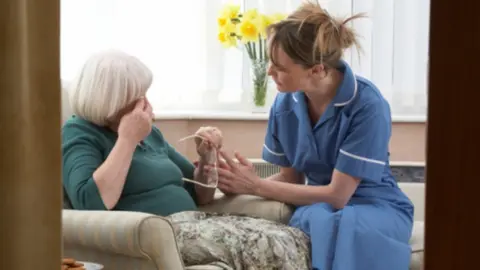 Getty Images A woman and a nurse