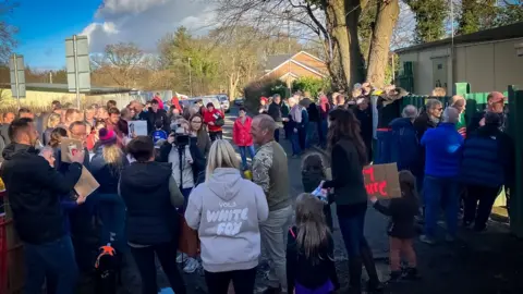 A group of people gathered outside a building