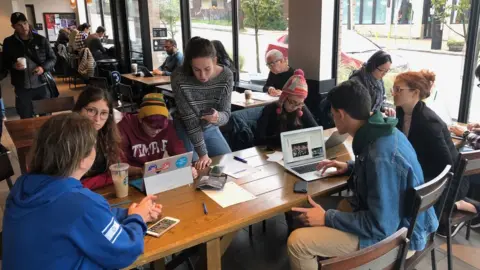 Andrea Glickman The children gather around a table in Starbucks