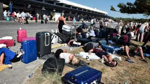 AFP Tourists gather outside terminal buildings at an airport on the island of Kos on July 21, 2017, after flights were cancelled following a 6.5 magnitude earthquake