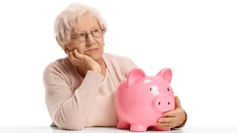 Getty Images woman with piggy bank