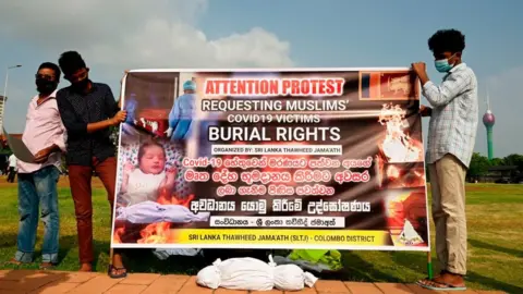 AFP Sri Lankan Muslims hold a banner as they demonstrate near the office of President Gotabaya Rajapaksa, in Colombo on December 16, 2020.