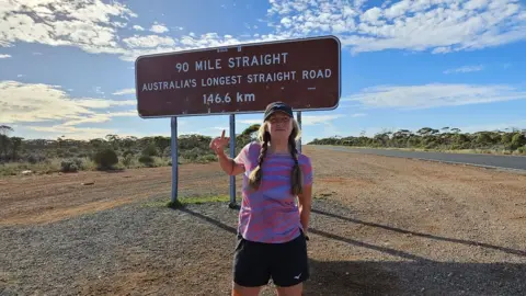 PA Media Nikki Love beside sign for Australia#s ;l