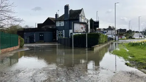 Kris Barrass/BBC A flooded car park