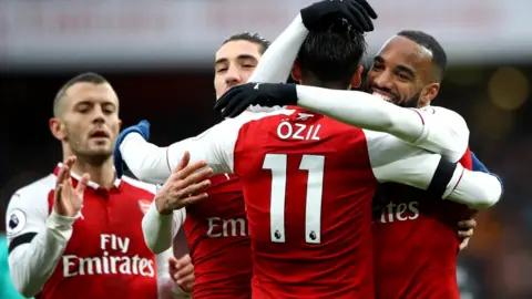 All Sport/Getty Images Arsenal players celebrate a goal
