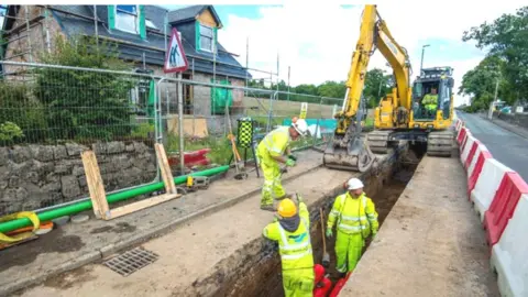 Roadbridge workers laying cable